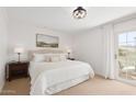 Cozy bedroom with a queen-sized bed, neutral tones, and a balcony access at 6229 N 30Th Way, Phoenix, AZ 85016