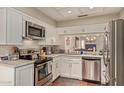 A charming kitchen with white cabinets, stainless steel appliances, and granite countertops at 6229 N 30Th Way, Phoenix, AZ 85016