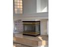 Modern fireplace with unique glass block windows providing natural light at 6416 N 78Th Ln, Glendale, AZ 85303