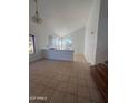 Spacious living room features a high ceiling, large windows, and tile flooring at 6416 N 78Th Ln, Glendale, AZ 85303