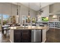 Open-concept kitchen with granite counters, center island, and view into the living room at 7501 E Phantom Way, Scottsdale, AZ 85255