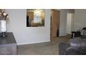 Cozy carpeted living room view into kitchen at 7807 E Main St # F24, Mesa, AZ 85207