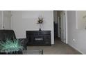 Carpeted living room with open doorway and dark furniture at 7807 E Main St # F24, Mesa, AZ 85207