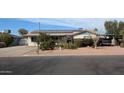 Charming single-story home featuring solar panels, a xeriscaped front yard, and a cozy covered parking area at 1116 E 11Th E St, Casa Grande, AZ 85122