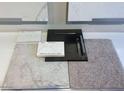 Selection of design studio finishes including flooring, countertops and cabinetry at 12219 W Caraveo Pl, Peoria, AZ 85383