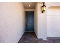 Close-up of the front door with brick entryway and exterior light at 12219 W Caraveo Pl, Peoria, AZ 85383