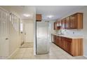 Bright kitchen featuring stainless steel appliances, wooden cabinets, and tile flooring at 12627 N La Montana Dr # 104, Fountain Hills, AZ 85268
