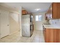 Well-lit kitchen featuring stainless steel appliances, wooden cabinets, and tile flooring at 12627 N La Montana Dr # 104, Fountain Hills, AZ 85268