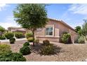 Exterior side view of home with tree, rock ground cover, bushes, and lawn at 13110 W Avenida Del Rey --, Peoria, AZ 85383