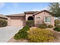 Charming single-story home featuring a well-maintained yard, a two-car garage, and a classic tile roof at 13110 W Avenida Del Rey --, Peoria, AZ 85383