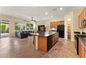 Open concept kitchen featuring an island, breakfast bar, stainless steel appliances, and adjacent living area at 13110 W Avenida Del Rey --, Peoria, AZ 85383