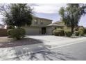 Two story home featuring landscaped front yard and three car garage at 1325 E Brent Ct, Casa Grande, AZ 85122
