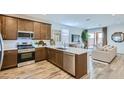 Open kitchen with stainless steel appliances and a view to the living room at 15763 W Pioneer St, Goodyear, AZ 85338