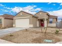 Exterior view of home with desert landscaping, red door and 2 car garage at 17081 W Seldon Ln, Waddell, AZ 85355