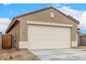Exterior view of a home's two-car garage, showing the driveway, exterior paint, and landscaping at 17081 W Seldon Ln, Waddell, AZ 85355