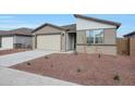 Charming single-story home featuring a two car garage and low maintenance desert landscaping at 17322 W Via Dona Rd, Surprise, AZ 85387
