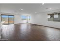 Bright living room featuring neutral walls, recessed lighting, and wood-look tile flooring at 17322 W Via Dona Rd, Surprise, AZ 85387