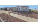 Charming single-story home featuring a desert landscape and a two car garage at 17445 W Via Dona Rd, Surprise, AZ 85387