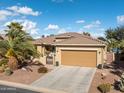 Charming single-story home featuring a spacious garage, desert landscaping, and a welcoming front entrance at 20623 N Enchantment Pass, Maricopa, AZ 85138