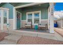 Close up of the home's covered porch with a door and two chairs at 2206 S Ellsworth Rd # 149B, Mesa, AZ 85209