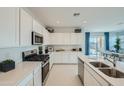 Modern kitchen with white cabinets, stainless steel appliances, and plenty of counter space at 24990 N 174Th Ave, Surprise, AZ 85387