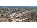 Expansive aerial view of a residential community showcasing lush green landscaping and mature trees at 3800 E Lincoln Dr # 7, Phoenix, AZ 85018