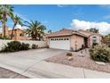 Charming home featuring a two-car garage, tiled roof and low maintenance desert landscaping at 4013 E Woodland Dr, Phoenix, AZ 85048