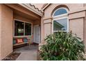 Inviting front porch with a seating area and security door, complemented by desert landscaping at 4013 E Woodland Dr, Phoenix, AZ 85048