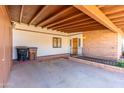 Covered carport featuring brick accents, wooden ceiling, and access to the front door at 412 W Fairhaven Rd, Kearny, AZ 85137