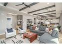 Open-concept living room featuring an expansive sofa, modern decor, and an adjacent kitchen at 43720 N Acadia Way, New River, AZ 85087