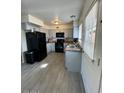 Charming kitchen featuring white cabinetry, stainless steel appliances, and wood-look floors at 4537 N 26Th Dr, Phoenix, AZ 85017