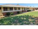 Well-maintained single-level home with brick accents, shuttered windows, and an attached two car garage at 4909 E Osborn Rd, Phoenix, AZ 85018
