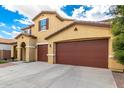 Stunning home featuring a tile roof, attached three-car garage, and long driveway at 7975 W Andrea Dr, Peoria, AZ 85383