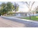 This property features a spacious driveway and a covered parking area, providing convenience and protection at 8002 N 5Th Ave, Phoenix, AZ 85021