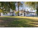 Beautiful home showcasing a lush green lawn with mature trees providing ample shade at 8002 N 5Th Ave, Phoenix, AZ 85021