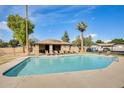 Outdoor pool area with lounge chairs, cabana, and palm tree at 828 W Laguna Dr, Tempe, AZ 85282