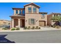 Charming two-story home featuring stucco siding, a tile roof, and a well-maintained front yard at 9923 E Texas Ave, Mesa, AZ 85212
