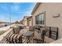Cozy front patio with outdoor seating, perfect for relaxing and enjoying the neighborhood views at 11123 E Olla Ave, Mesa, AZ 85212