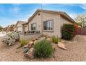 Beautiful desert landscaping featuring rocks, cacti, and shrubs surrounding the charming single-story home at 11123 E Olla Ave, Mesa, AZ 85212