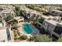 Aerial view of community pool and spa surrounded by condos and mature landscaping at 11260 N 92Nd St # 1060, Scottsdale, AZ 85260