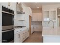 Bright kitchen featuring white cabinets, stainless steel appliances, and gold fixtures at 1254 E Penedes Dr, Gilbert, AZ 85298