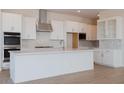 Bright kitchen featuring white cabinets, stainless steel appliances, and island with gold fixtures at 1254 E Penedes Dr, Gilbert, AZ 85298