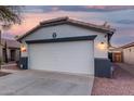 Spacious two-car garage with modern lighting and a security system for added peace of mind at 12630 W Aster Dr, El Mirage, AZ 85335