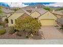 Aerial view of a home with a two-car garage and beautiful desert landscaping at 13344 W Via Caballo Blanco --, Peoria, AZ 85383