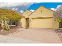Charming home featuring a brick driveway, two-car garage, and beautiful desert landscaping at 13344 W Via Caballo Blanco --, Peoria, AZ 85383