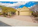 A home featuring desert landscaping, a brick driveway and a two-car garage at 13344 W Via Caballo Blanco --, Peoria, AZ 85383