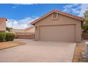 Charming single-story home featuring a two-car garage, desert landscaping, and a terracotta-tiled roof at 1365 N El Dorado Dr, Chandler, AZ 85224