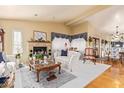 Cozy living room with fireplace, hardwood floors, neutral walls, and traditional-style decor at 1365 N El Dorado Dr, Chandler, AZ 85224