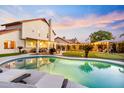 Beautiful backyard pool with lounge chairs and a view of the covered patio and putting green at 17614 N 56Th Way, Scottsdale, AZ 85254