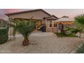 Private backyard features desert landscaping, a cozy seating area, a built in grill, and a gazebo at 17938 W Cedarwood Ln, Goodyear, AZ 85338